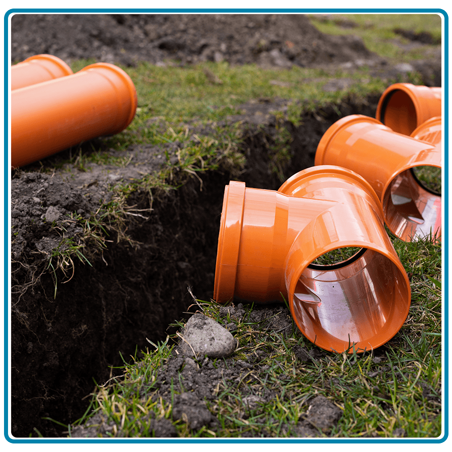 Orange PVC sewer pipes ready for underground installation