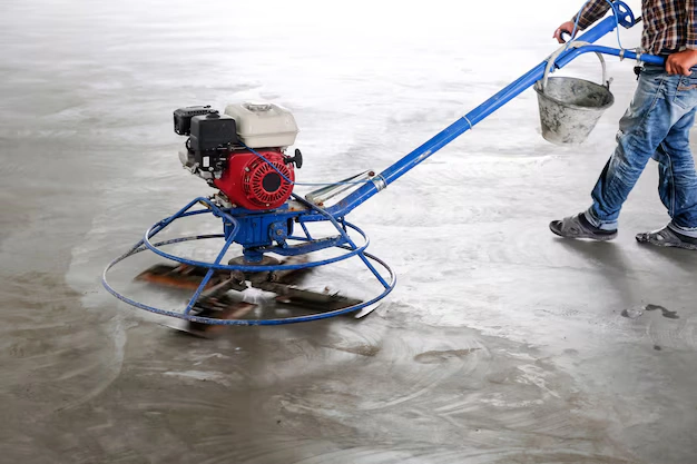 contractor using power trowel to restore concrete after hydro jetting sewer line access in Portland